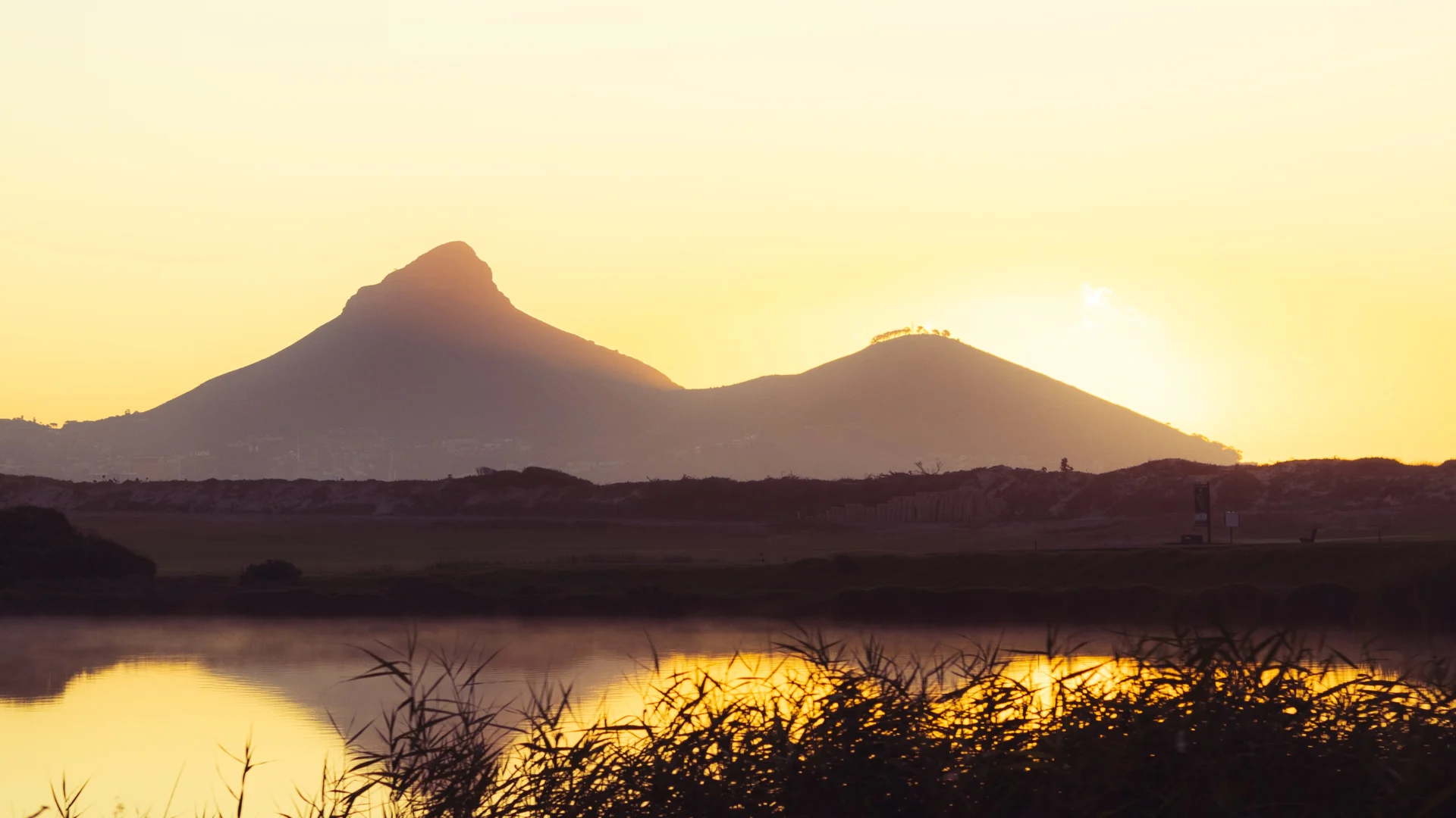 Sunset over mountains and reflected water