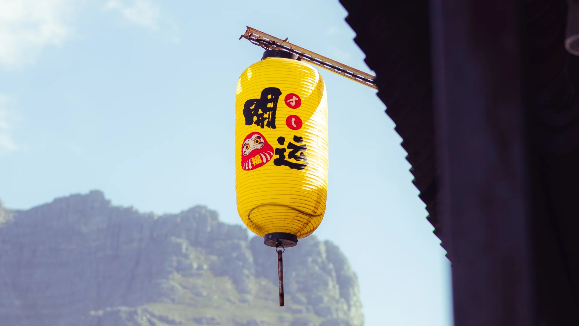 Yellow lantern with a mountain backdrop