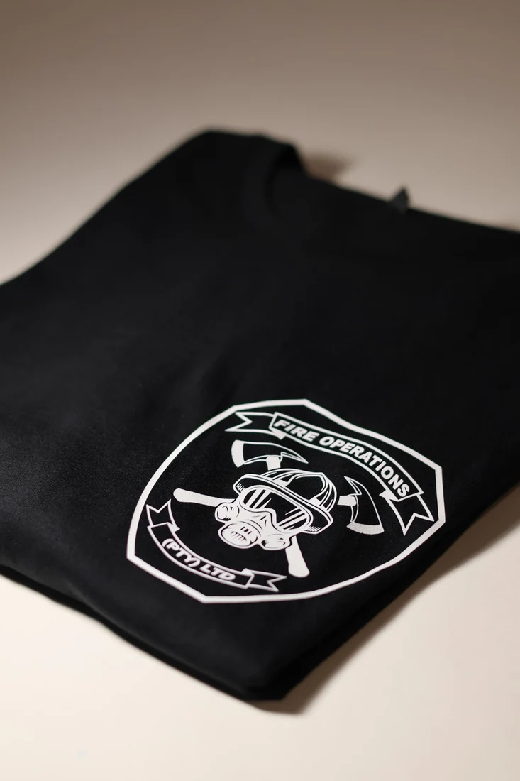 White Fire Operations garment print on black fabric
