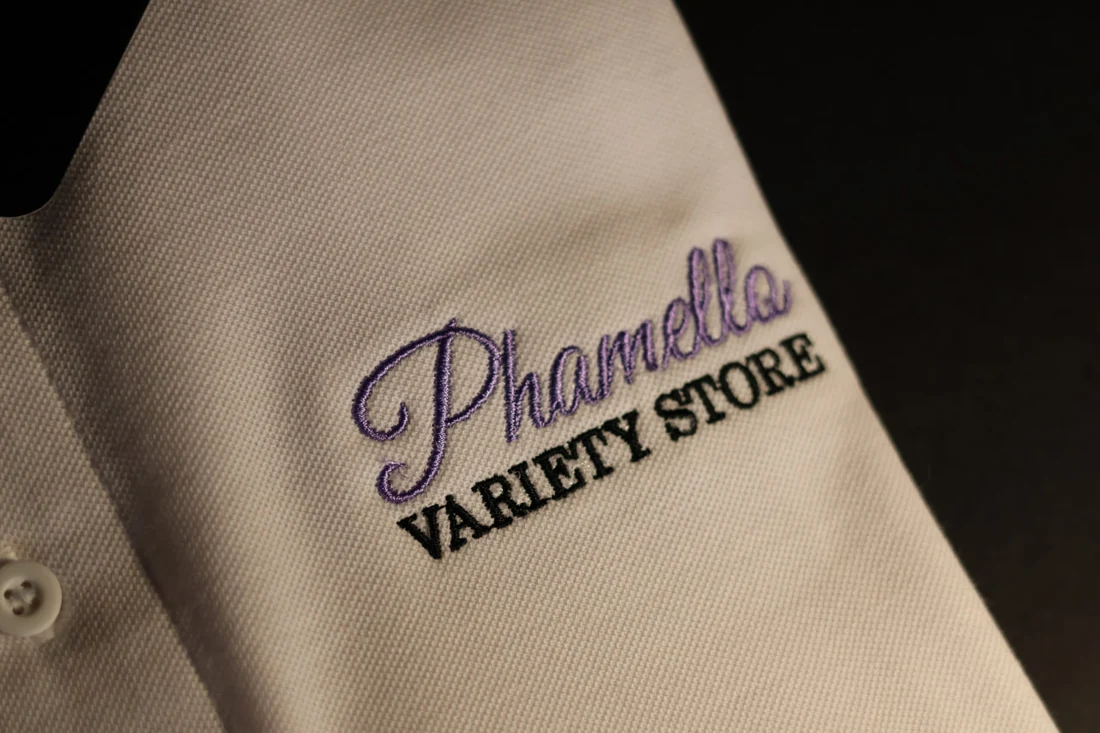 Phamello Variety Store embroidery on a cream shirt