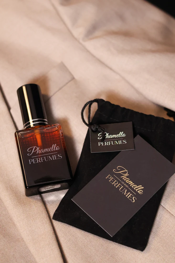 Engraved Phamello perfume bottle and packaging on cream fabric