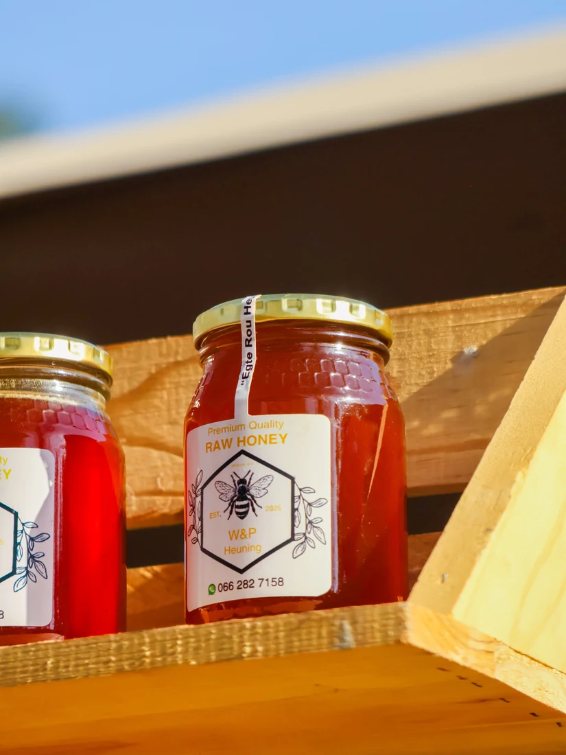 Food jars arranged on a wooden shelf