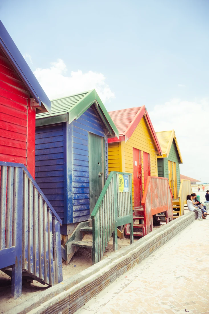 Colourful beach huts photographed along a row