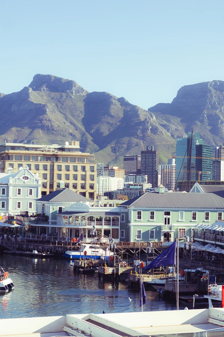 Waterfront buildings with a mountain backdrop
