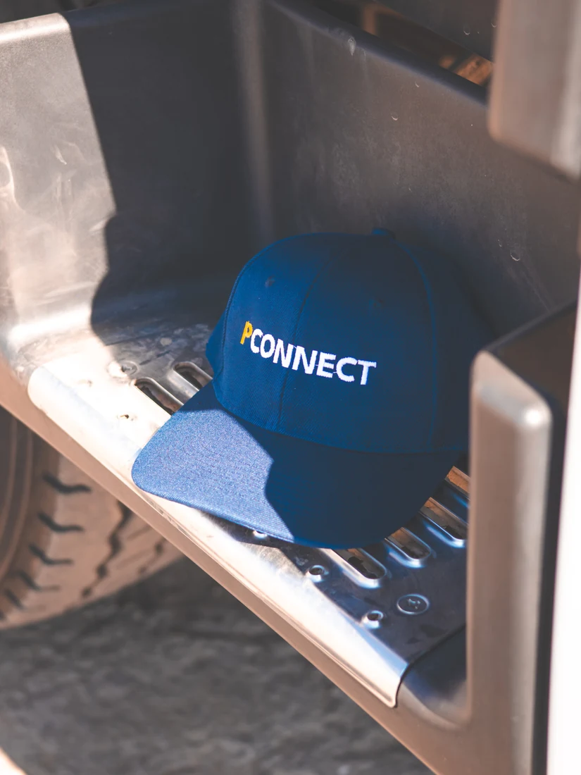 PConnect branded navy shirt on a chair
