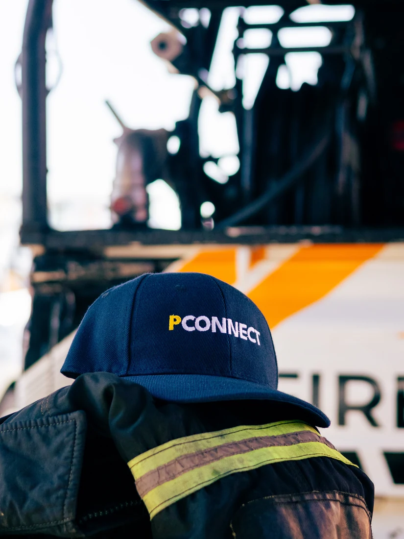 PConnect safety workwear and cap on a chair