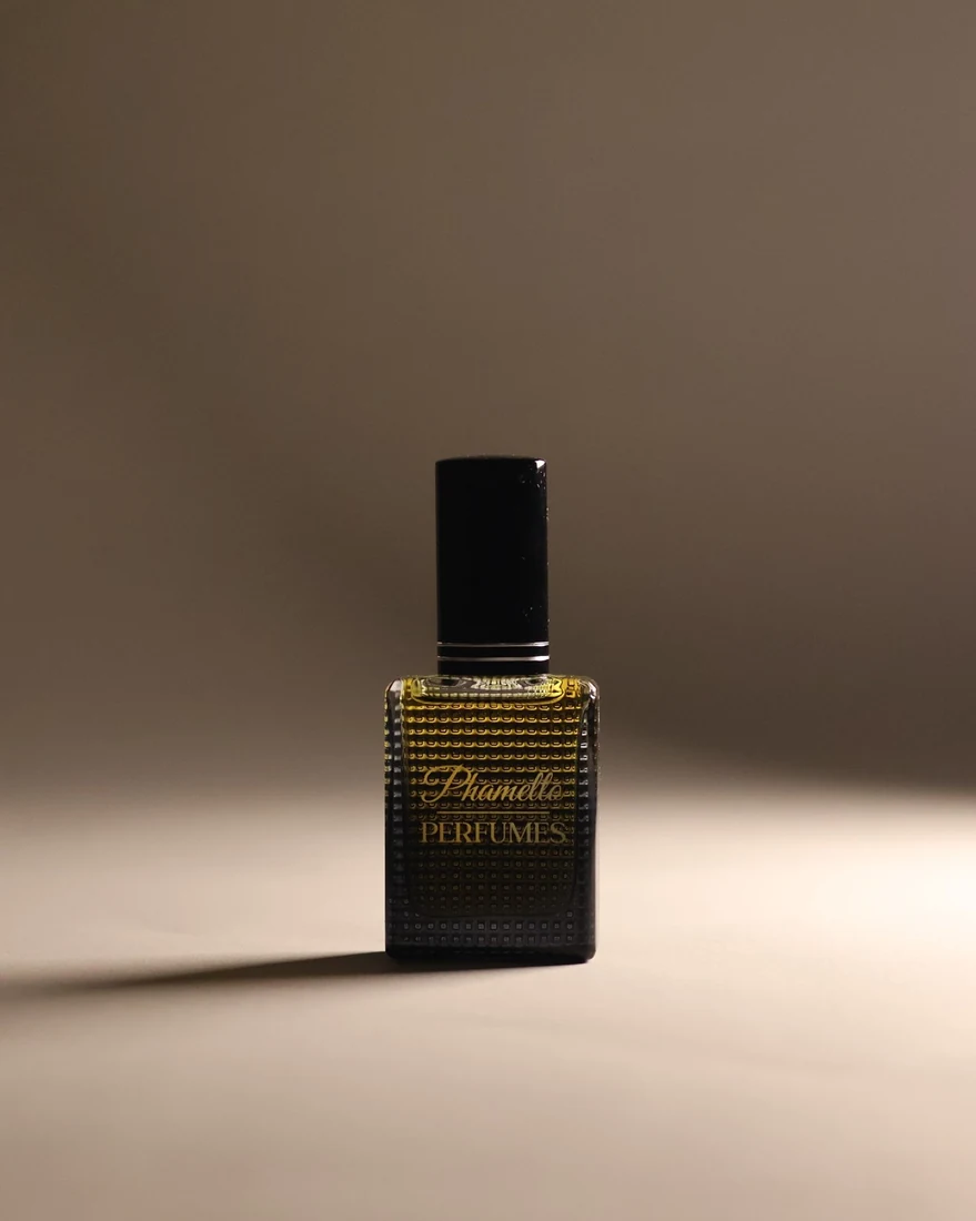 Perfume bottle against a warm studio backdrop