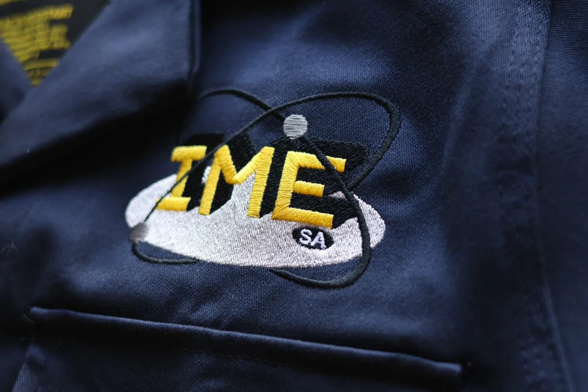 IME logo embroidered on navy fabric